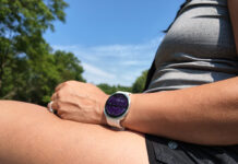 Samsung Galaxy Watch 9 on a wrist resting on a leg outside.