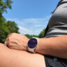 Samsung Galaxy Watch 9 on a wrist resting on a leg outside.