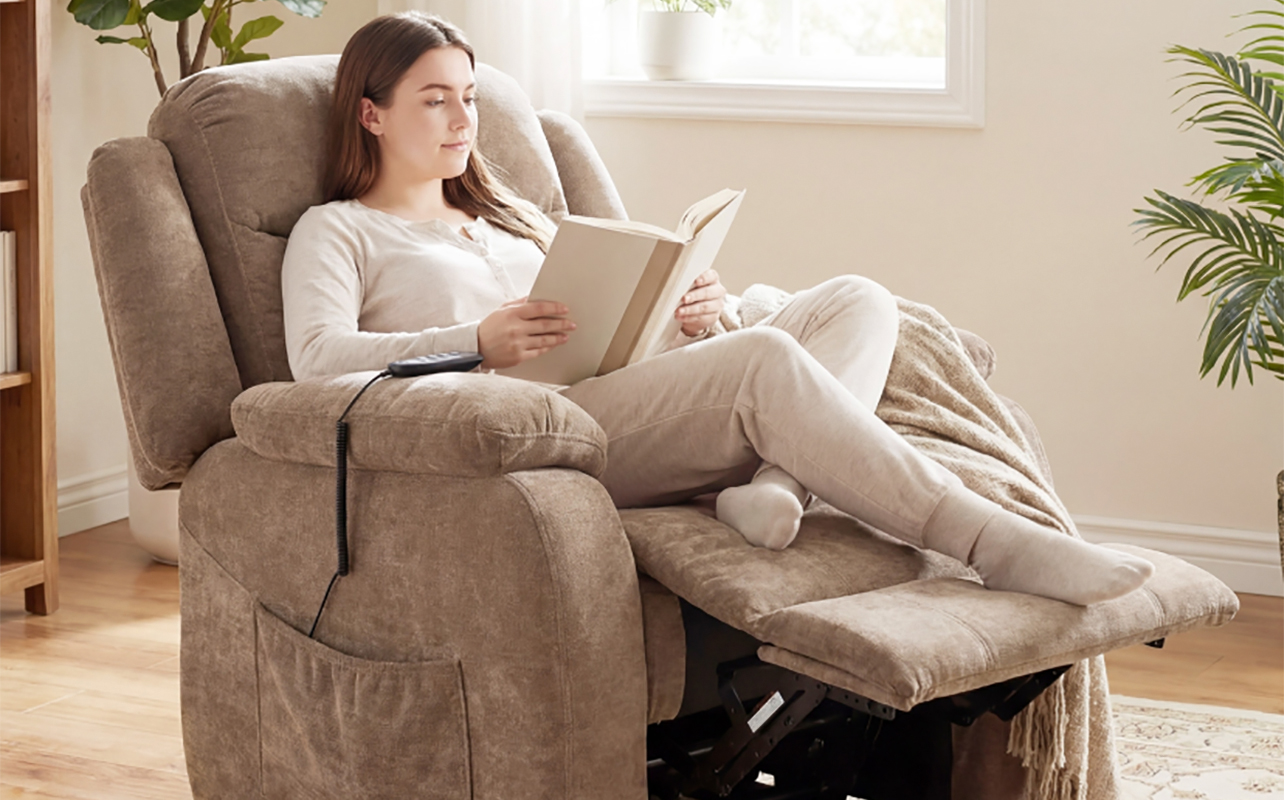 A woman relaxing in a Homcom power recliner with massage reading a book.