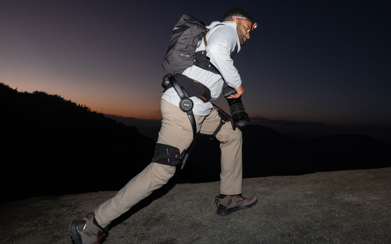 A man hiking wearing a Hypershell exoskeleton
