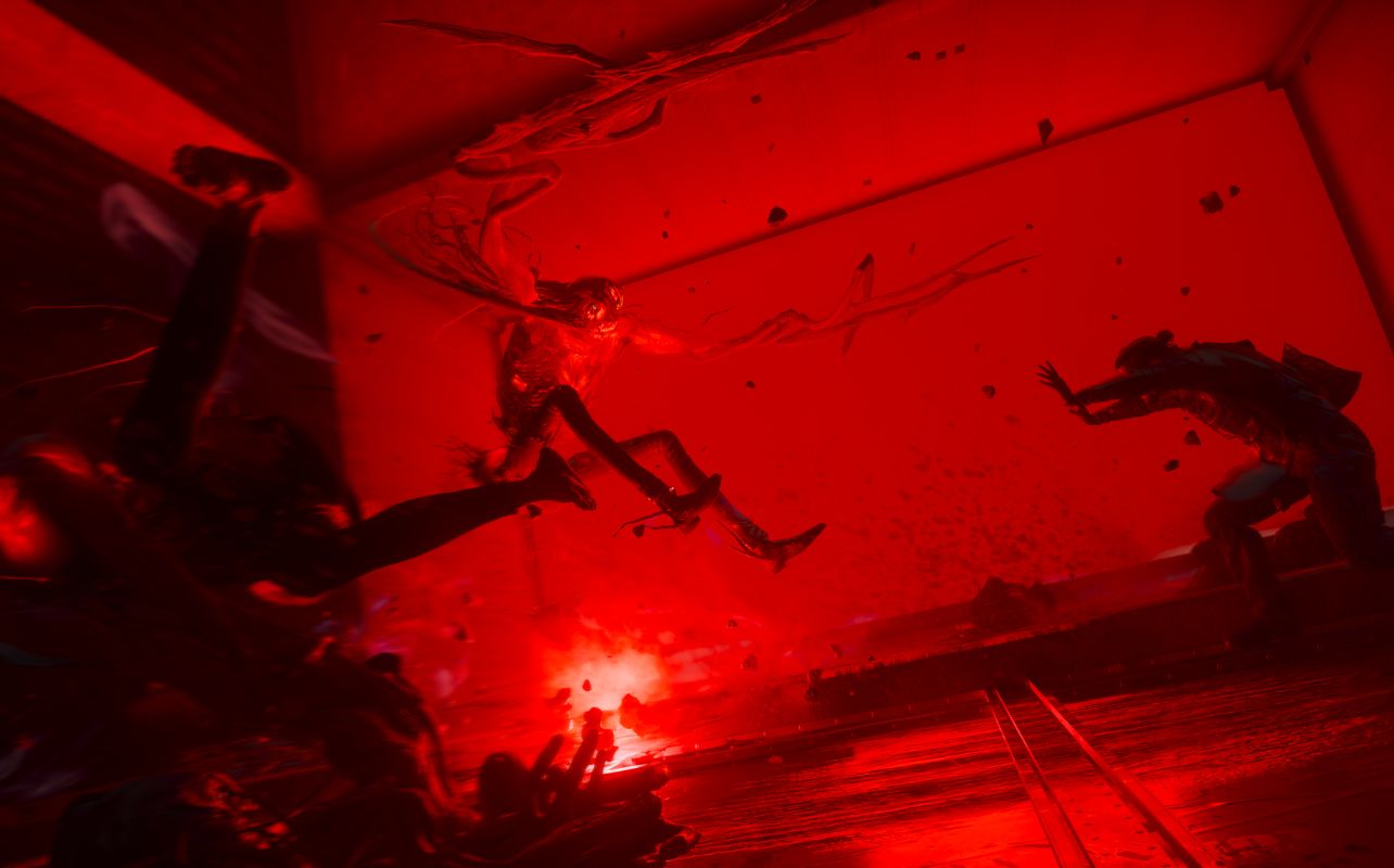 A silhouetted character battles monsters in a very red-lit area, adding drama.