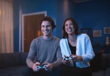 Two people playing PS5 with DualSense wireless controllers.