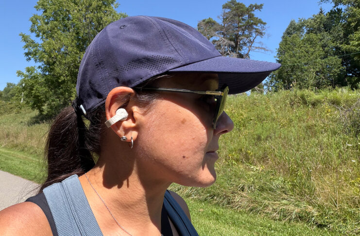 A woman wearing the Sennheiser Accentum Clip buds on a trail.