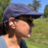 A woman wearing the Sennheiser Accentum Clip buds on a trail.