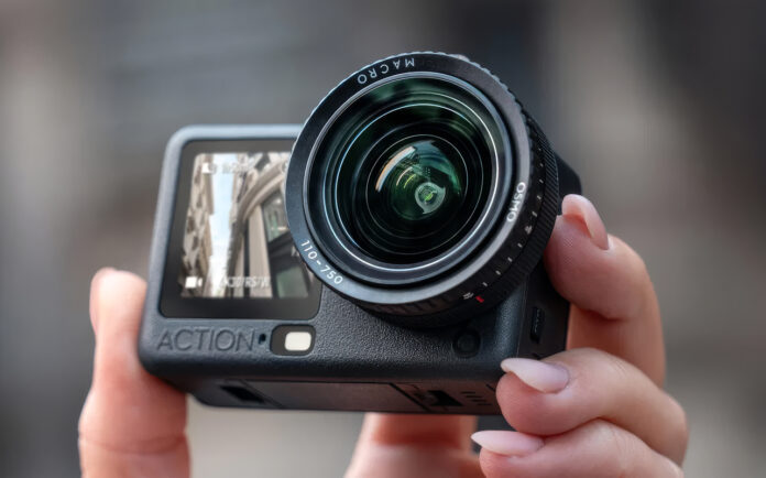 Close-up of person holding DJI Osmo Action 6 in hand.