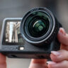 Close-up of person holding DJI Osmo Action 6 in hand.