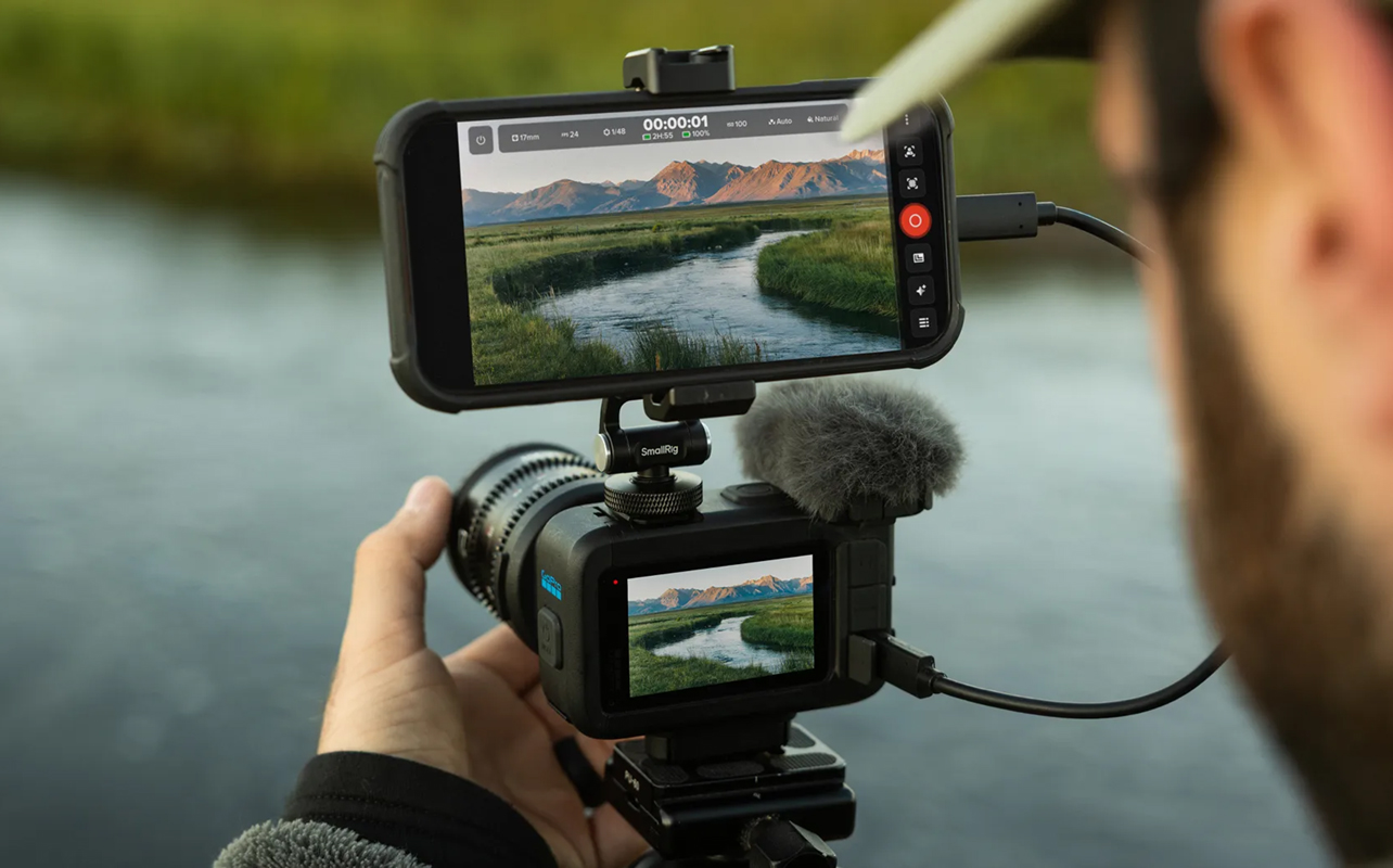 Man using GoPro Mission 1 Pro tethered to smartphone.