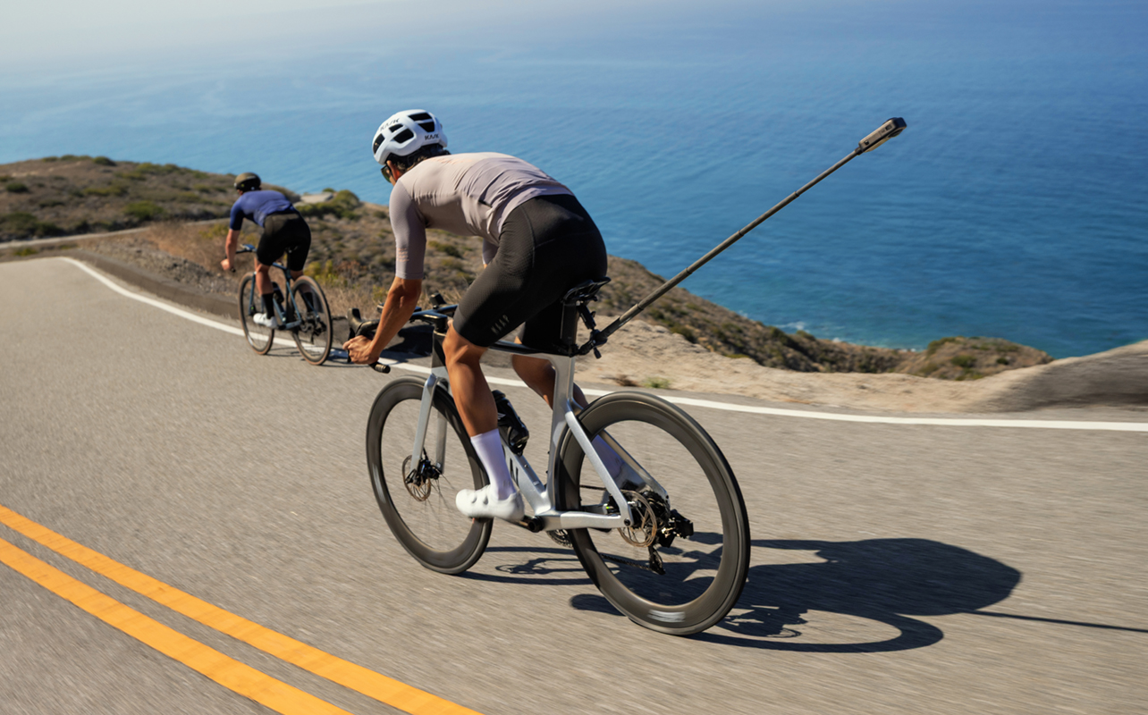 Man cycling with Insta360 X6 mounted behind him.