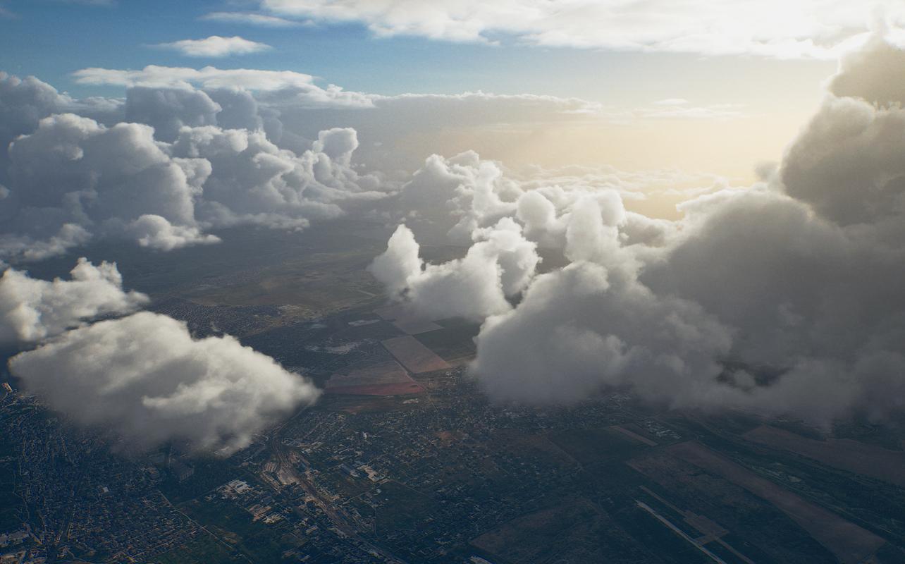 Ace Combat 8: Wings of Theve aerial view showing large clouds over the landscape with sunlight breaking through.
