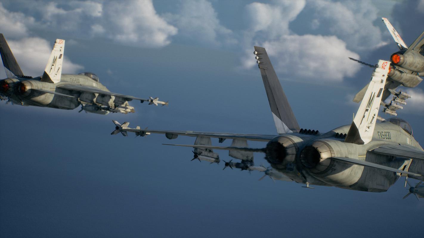 Ace Combat 8: Wings of Theve fighter jets flying through the sky with missiles mounted beneath their wings.