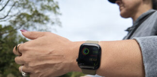 A woman holding her arm out with the Apple Watch Series 12.