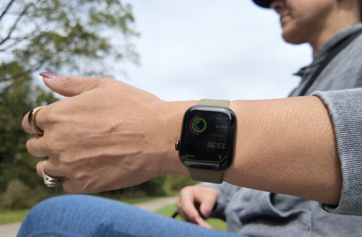 A woman holding her arm out with the Apple Watch Series 12.