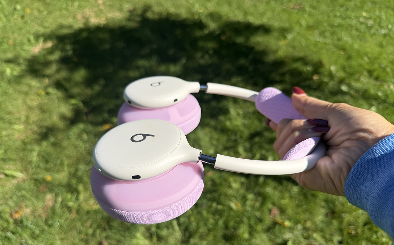 The Beat 360 headphones held sideways outside with pink ear cushions
