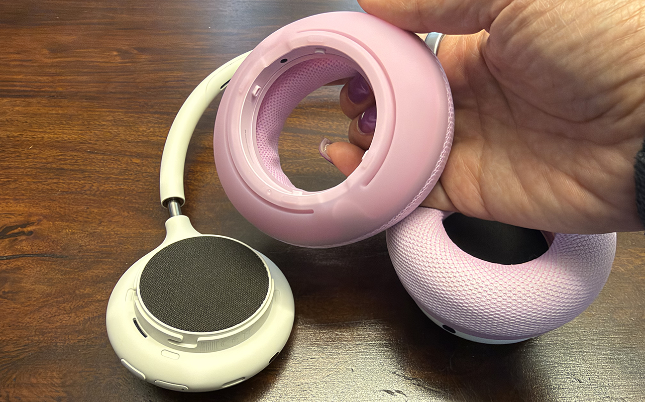 The Beats 360 headphones with a pink earcup cushion removed.