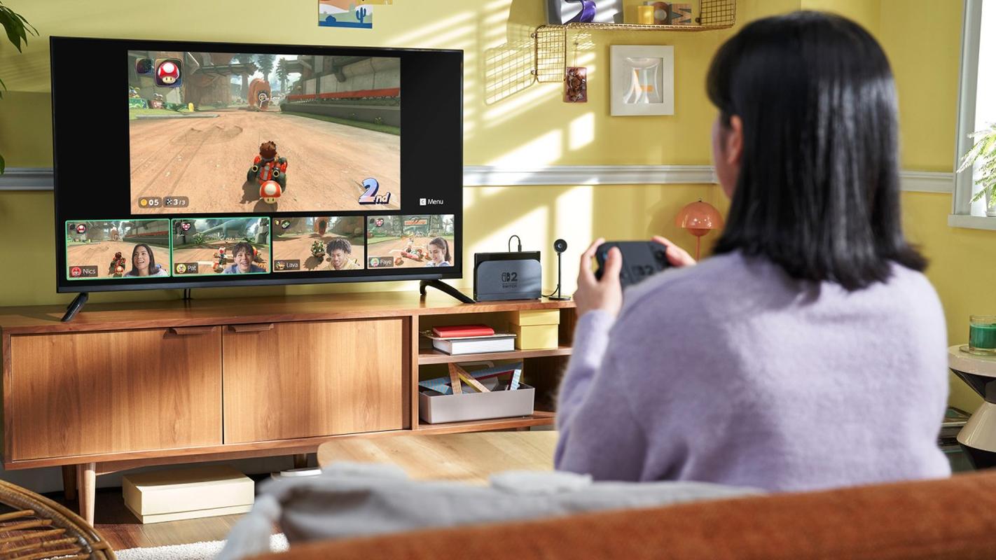 Person playing Nintendo Switch 2 on a TV with a Joy-Con 2 controller.