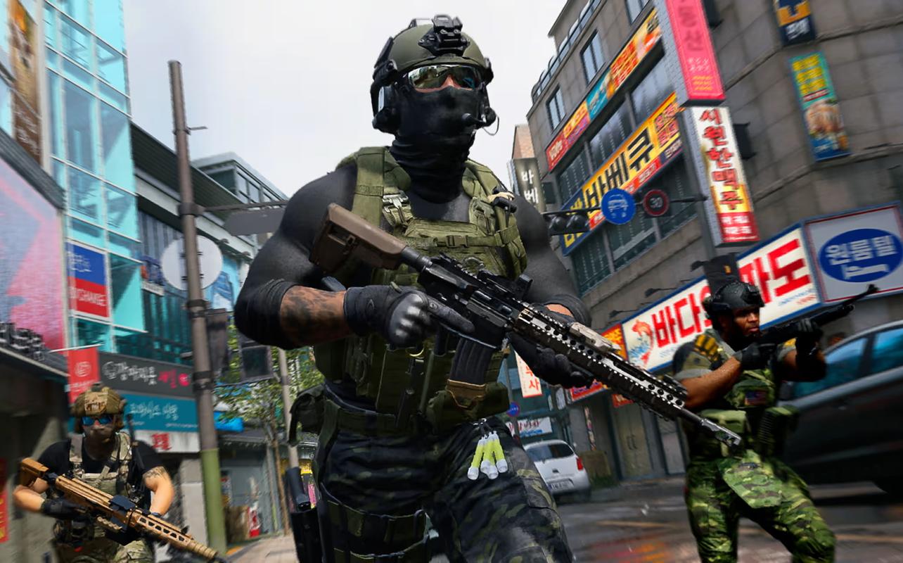 Three armed soldiers advancing through a city street lined with Korean storefronts in Call of Duty: Modern Warfare 4.